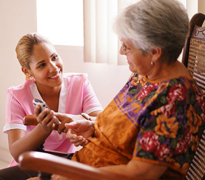 happy nurse with elderly woman