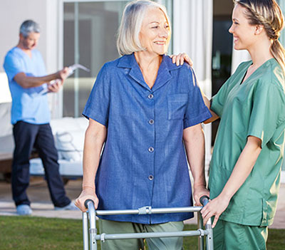 nurse helping elderly woman